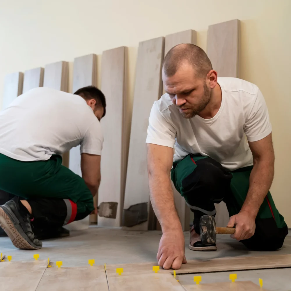 full-shot-workers-tiling-floor-indoors